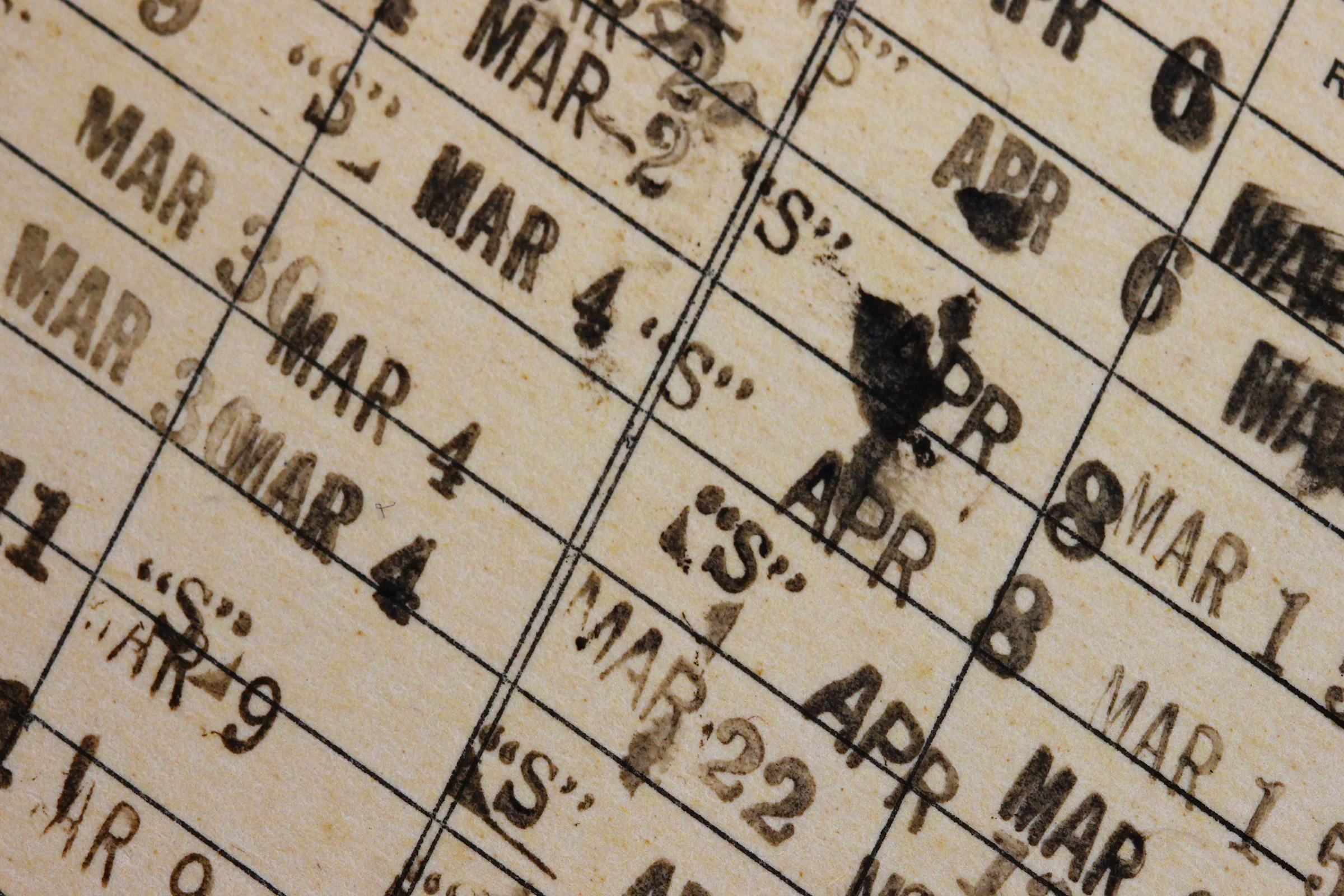Close view of date stamps on a vintage library card